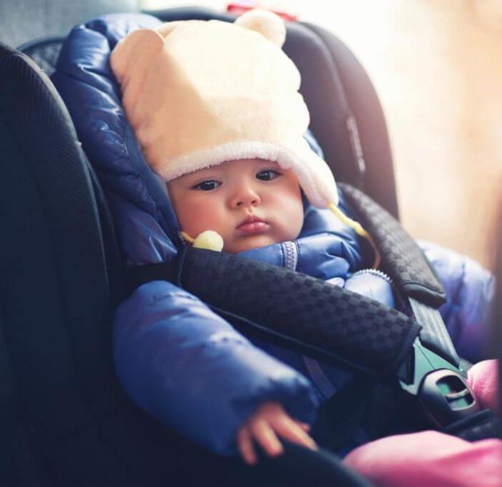Why do puffy winter coats compromise car seat safety