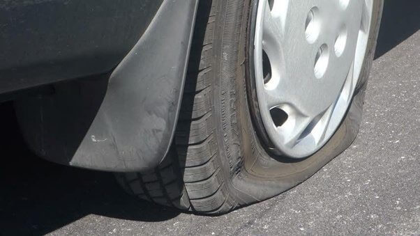 a vehicle beinmg driven with under-inflated tire that needs refilling